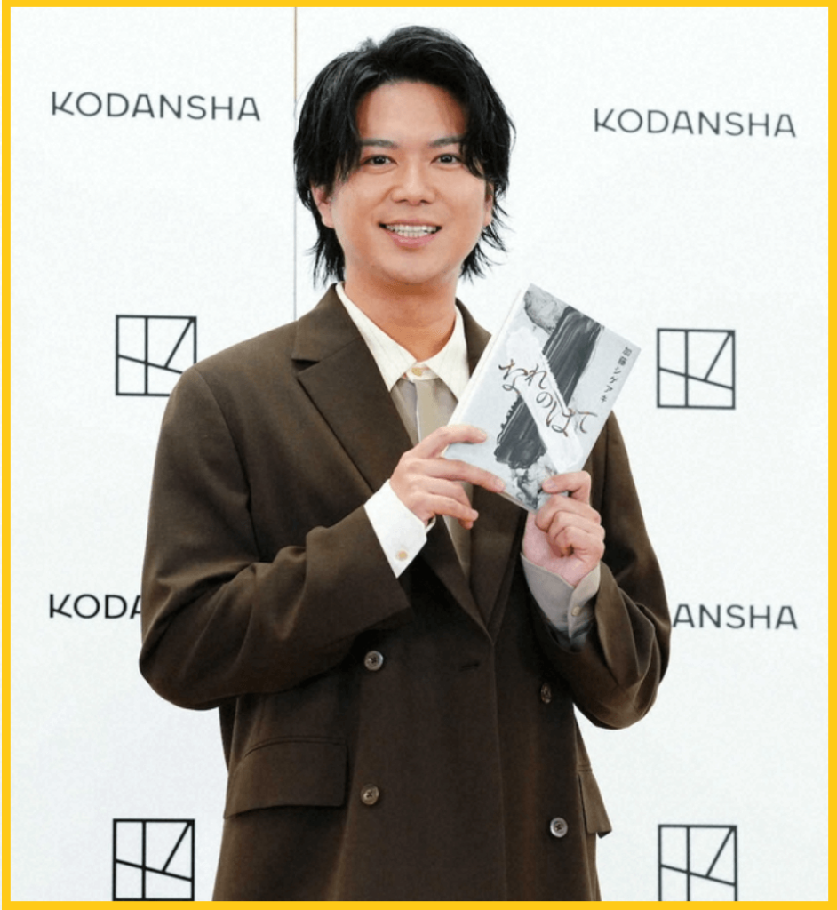 著書「なれのはて」を持って笑顔を見せる加藤シゲアキさんの画像